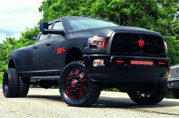 2012 Ram 3500 with full Matte Black vinyl wrap, custom red emblems, 24 inch American Force Dolla wheels (custom painted) with 37x13.50x24 Toyo Open Country MT tires.  Custom made Oracle headlights, Fog Lights, and LED light bar 
