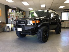 2013 Toyota FJ Cruiser with a Readylift SST lift kit with 18 inch XD Fusion wheels and 33 inch Nitto Ridge Grappler tires and Warrior Products front and rear bumper